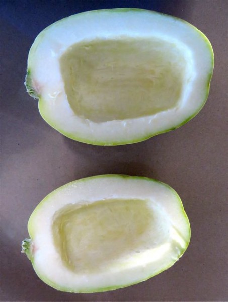 First step after washing the squash, cut it in half, lengthwise. Then scoop out the seeds.