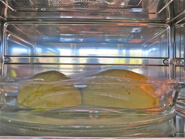 Now this is the secret to getting your squash cooked in record time. Place it face down on a microwaveable dish along with 1 -2 tablespoons of water. Loosely cover the squash and with George's okay I used saran wrap. Cook in the microwave for 10 minutes or until you can poke it right through with a fork.