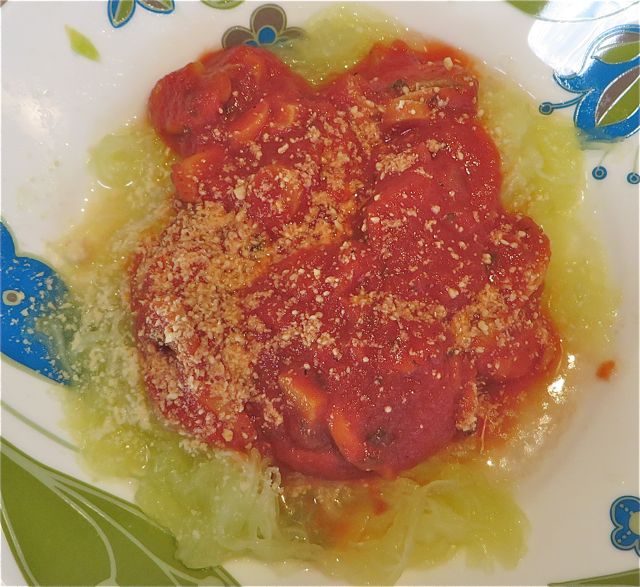 You then plate your strands of squash. I used large soup bowls. I had already heated up some jarred pasta sauce which I topped the squash with. Of course I added parmesan.