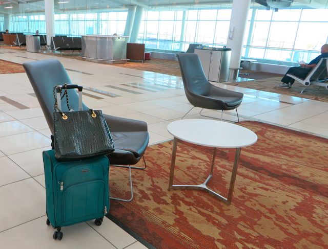 Spontaneous executive female decision. But the carry on bag on wheels. I just popped my tote in there and carried on. Good thing as the gate was at the farthest end possible and also I landed at the gate the furthest away here in Kelowna. It was meant to be. My back was saved.