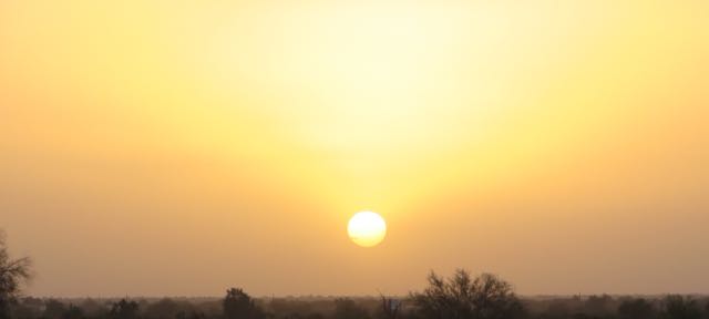 Very hazy all day, likely from the dust in the air. The sunset tonight reminded us of India, but it's much warmer there.