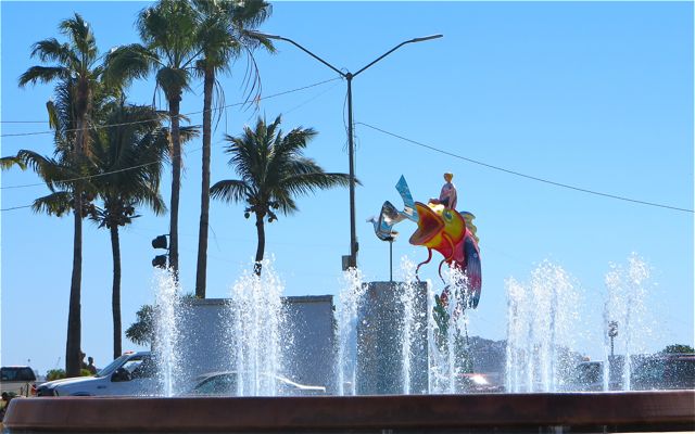 The new fountain feature at the newly crated round about in front of Valentinos. complete with a Carnival statue in the background.