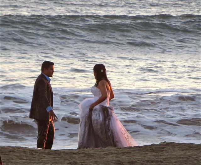 He is wet and her gown is damp and full of sand....romantic???