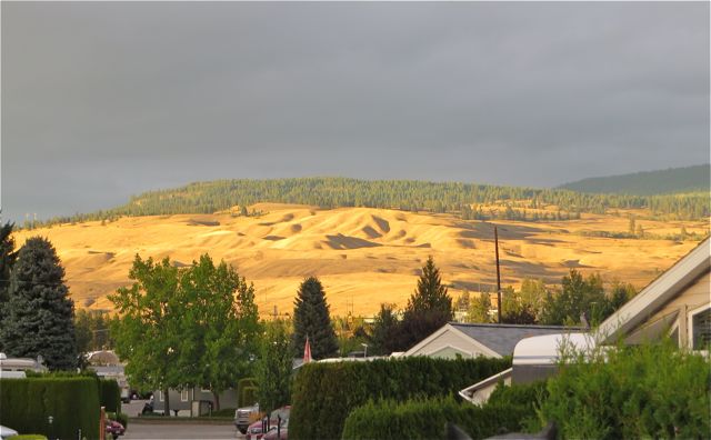 Golden light on hills across the lake from us.