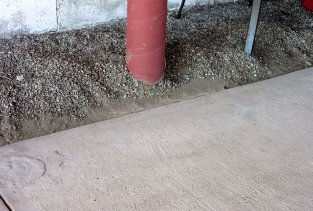 The first step was to push back the pea gravel from the edges.